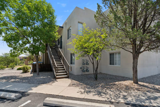 a white house with stairs and trees in front of it at Vista Linda, Santa Fe, NM