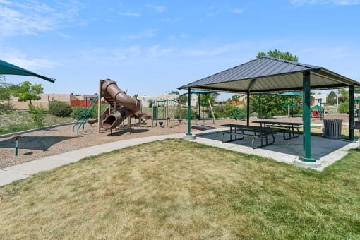 a playground with a slide and picnic table in a park at Vista Linda, Santa Fe, 87507