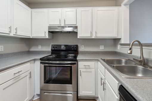 a kitchen with white cabinets and stainless steel appliances at Vista Linda, Santa Fe, New Mexico