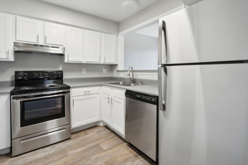 a kitchen with stainless steel appliances and white cabinets at Vista Linda, New Mexico