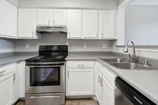 a kitchen with white cabinets and stainless steel appliances at Vista Linda, Santa Fe