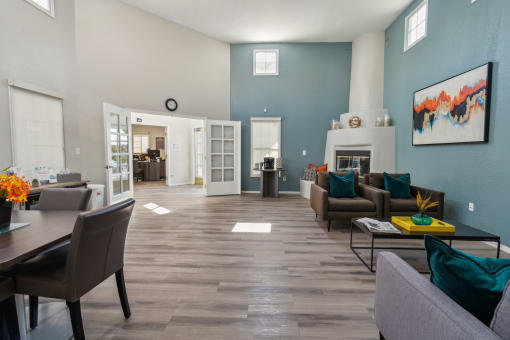 a living room and dining room with blue walls and a fireplace at Vista Linda, New Mexico 87507