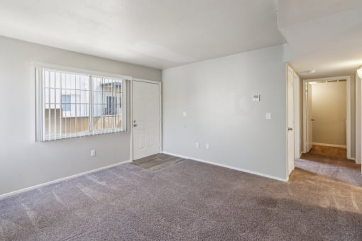 the living room of an empty apartment with white walls at Vista Linda, Santa Fe, NM 87507