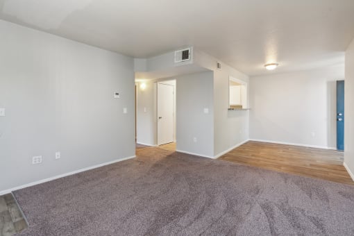 an empty living room with a wood floor and white walls at Vista Linda, Santa Fe, 87507
