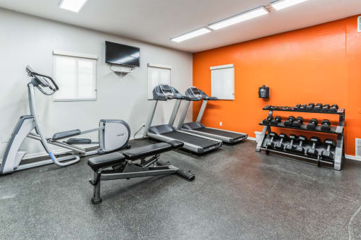 a workout room with weights and a tv in the corner at Vista Linda, Santa Fe, New Mexico