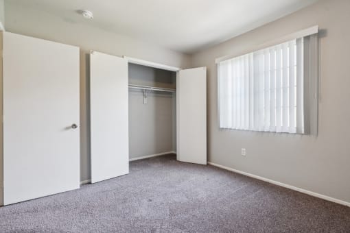 an empty bedroom with a closet and a window at Vista Linda, New Mexico 87507
