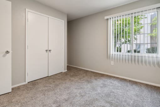 an empty bedroom with a window and a closet at Vista Linda, Santa Fe, NM