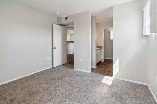 an empty living room with a hallway to a bedroom and a bathroom at Vista Linda, New Mexico
