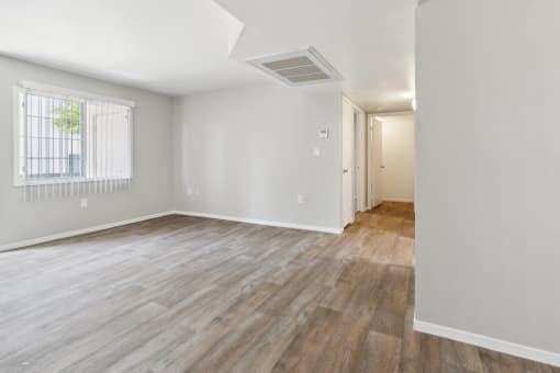 the living room and dining room of an apartment with wood flooring at Vista Linda, Santa Fe, New Mexico
