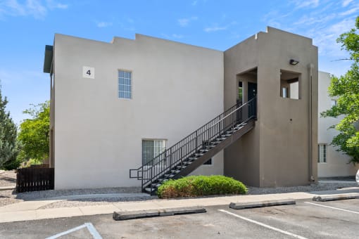A building with a number 4 on it has a staircase leading to the door at Vista Linda, Santa Fe, NM 87507