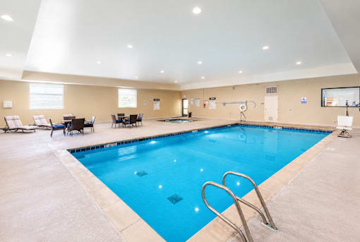 Indoor swimming pool with seating area at The Ellison Apartments, Utah, 84041