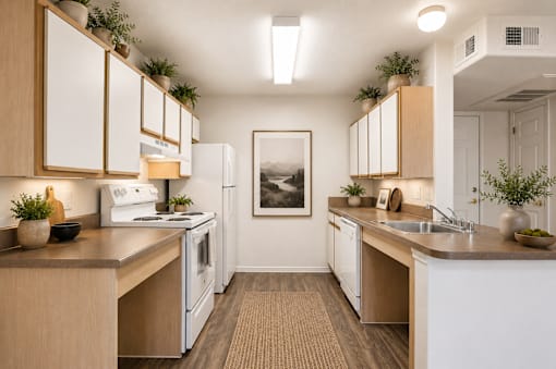 A kitchen with white appliances and wooden cabinets.