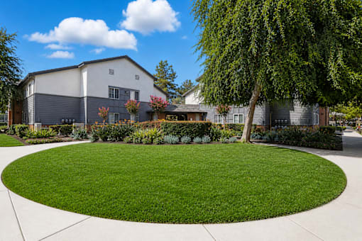A large grassy area in front of a building.