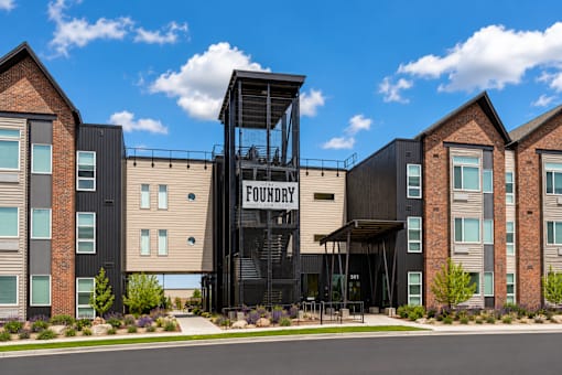 A building with a sign that says "FOUNDRY" is in front of other buildings.