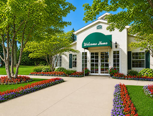Welcoming clubhouse entrance with colorful flower beds at Northview Park Apartments, Michigan, 48310