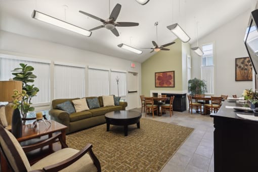 a living room and dining room with couches and chairs and a dining room table