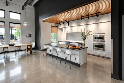A modern kitchen with a dining table and chairs.