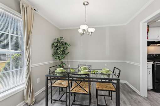 A dining room with a glass table and chairs.