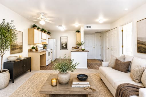 A living room with a white couch, a wooden coffee table, and a ceiling fan.