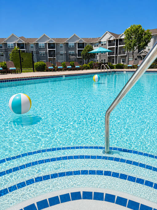 Resort style swimming pool with lounge chairs at Cypress Court Apartments, St Cloud, MN 56303