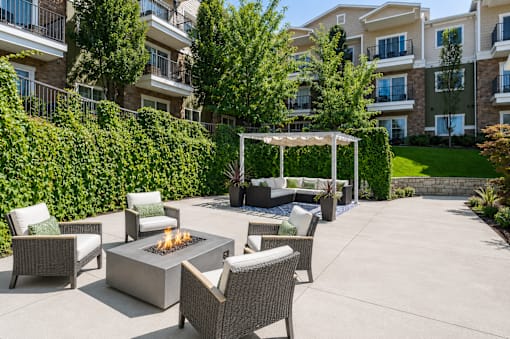 Outdoor courtyard with fire pit and seating area at The Ellison Apartments, Layton, UT