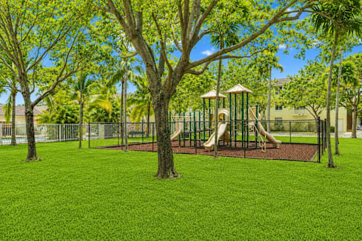 A playground with a slide and a swing set.