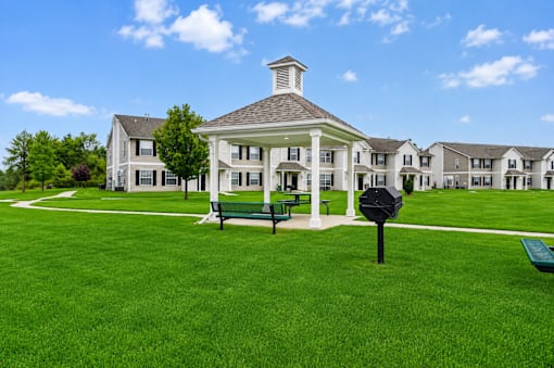 A white building with a black mailbox in front of it.