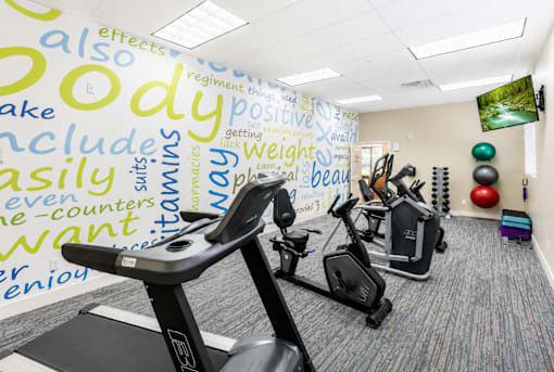 Fitness center with cardio and strength equipment at The Ellison Apartments, Layton