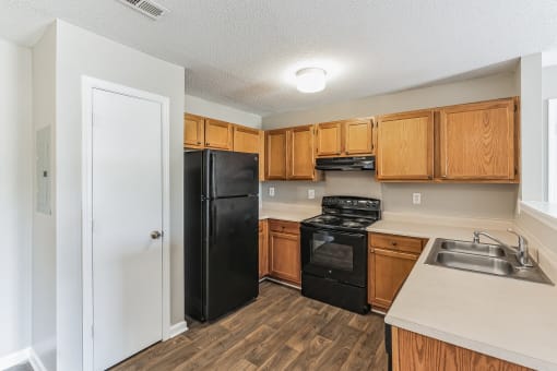 a kitchen with black appliances and wooden cabinets