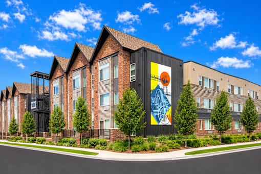 A modern building with a large mural on the side.