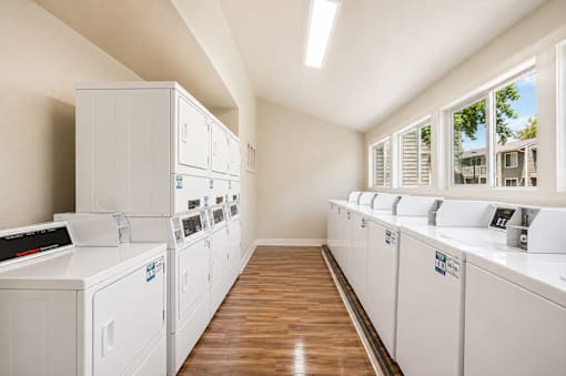 A laundry room with washers and dryers.