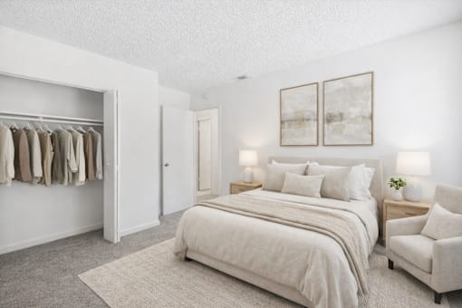 A bedroom with a large bed, a chair, and a wardrobe.