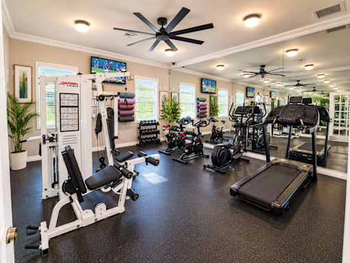 A spacious home gym with a variety of exercise equipment.