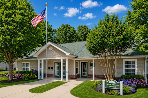 A small building with a flag on top and a sign in front that says "Future Homes".