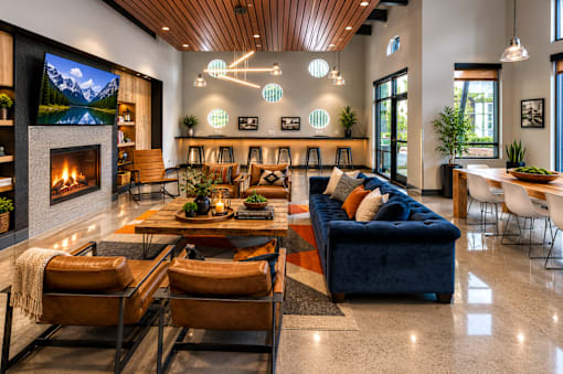 A modern living room with a fireplace and a large screen TV.