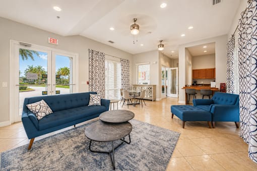 A living room with a blue couch and a coffee table.