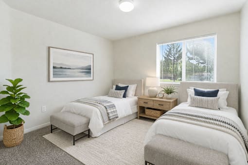 A bedroom with two beds, a nightstand, and a plant. at Diamond Fork Apartments, Spanish Fork