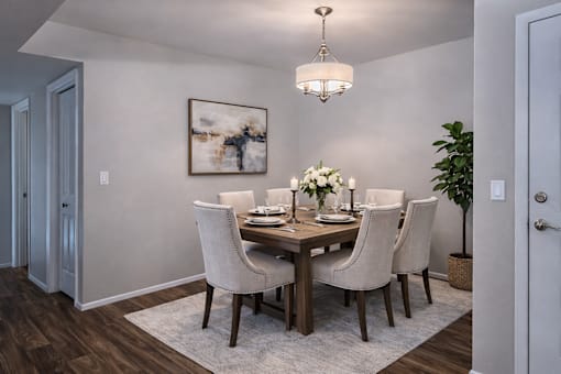 Dining room with wood table and upholstered chairs at Creekview Apartments, Utah