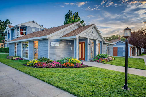 Leasing office exterior with colorful flower beds at Creekview Apartments, Utah, 84047
