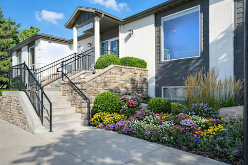 A house with a front yard and a stone wall.