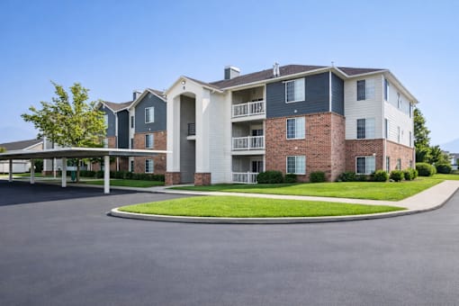 A large apartment complex with a parking lot in front at Haven Pointe Apartments, Apartments, West Haven, UT