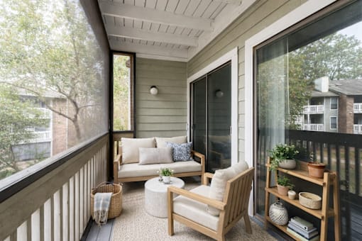 A balcony with a sofa, chair, and table. at Parkland at Orange Park Apartments , Apartments, Orange Park, FL