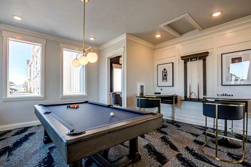 A pool table in a room with a striped carpet.