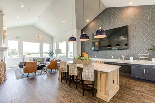 A kitchen with a dining table and chairs.