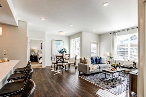 A modern living room with a grey couch and a coffee table.