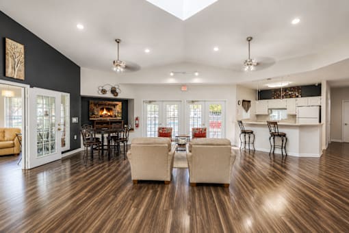 Clubhouse lounge with fireplace and kitchen bar at Northview Park Apartments, Sterling Heights, Michigan