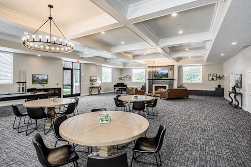 Spacious clubhouse lounge with fireplace and seating at The Ellison Apartments, Utah, 84041