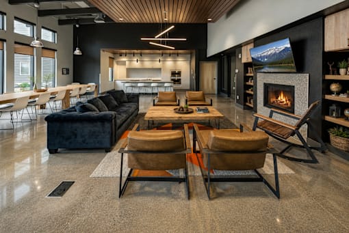 A modern living room with a fireplace and a large couch.