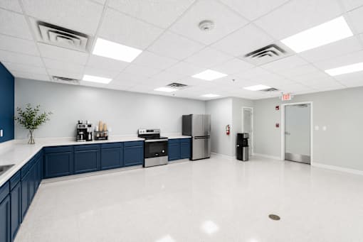 A clean, empty office space with blue accent walls and white floors.