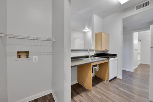 a kitchen with a sink and a counter top in a renovated apartment